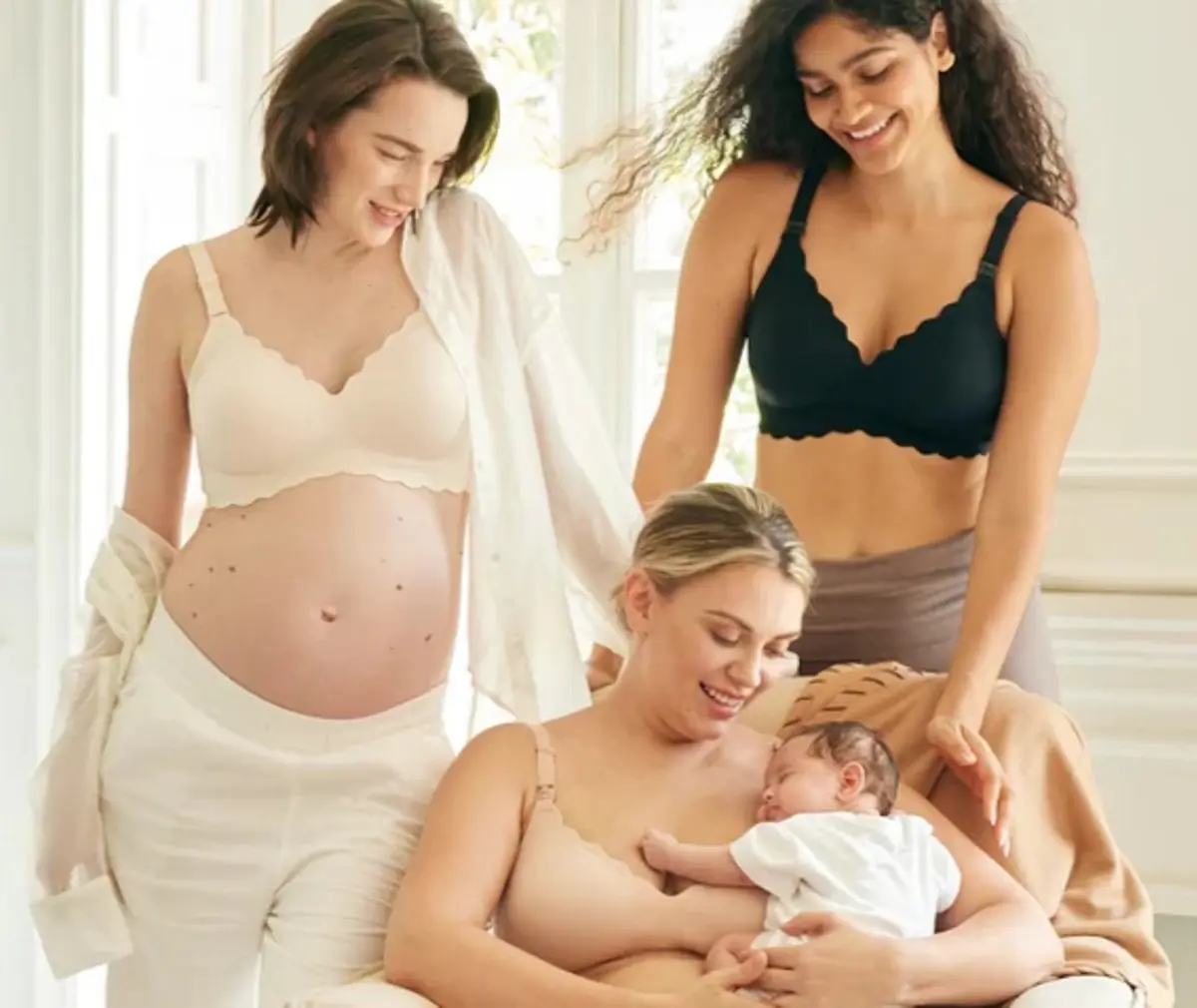 Three women in Momcozy nursing bras. One is holding a baby.