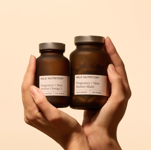 2 bottles of Wild Nutrition supplements in a pair of hands