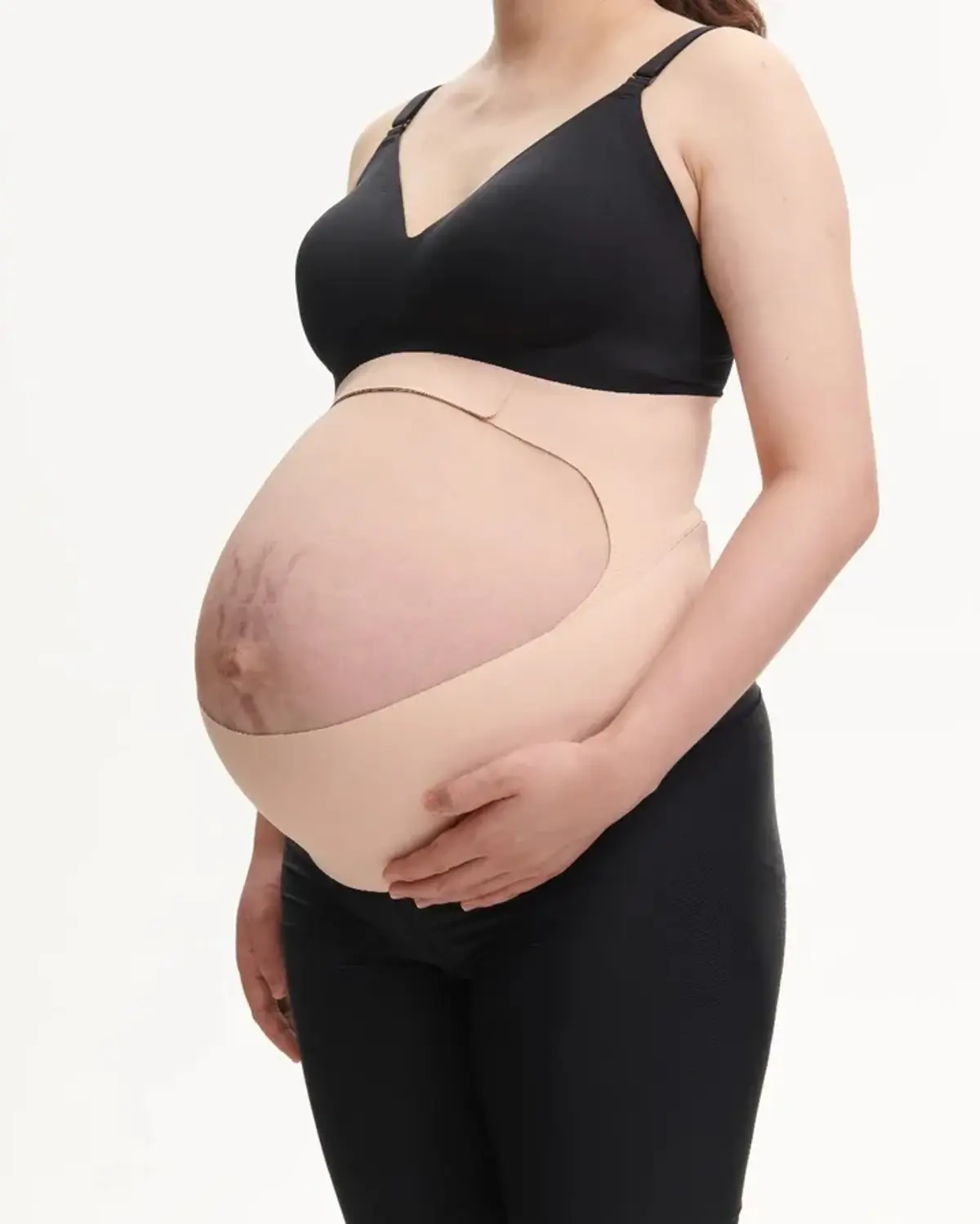 A pregnant woman wearing a supportive belly band