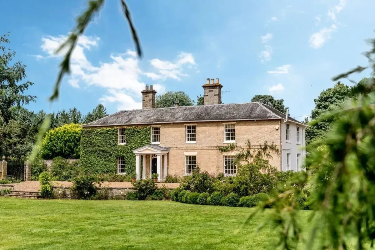 A grand Luxury Cottages country house and lawn