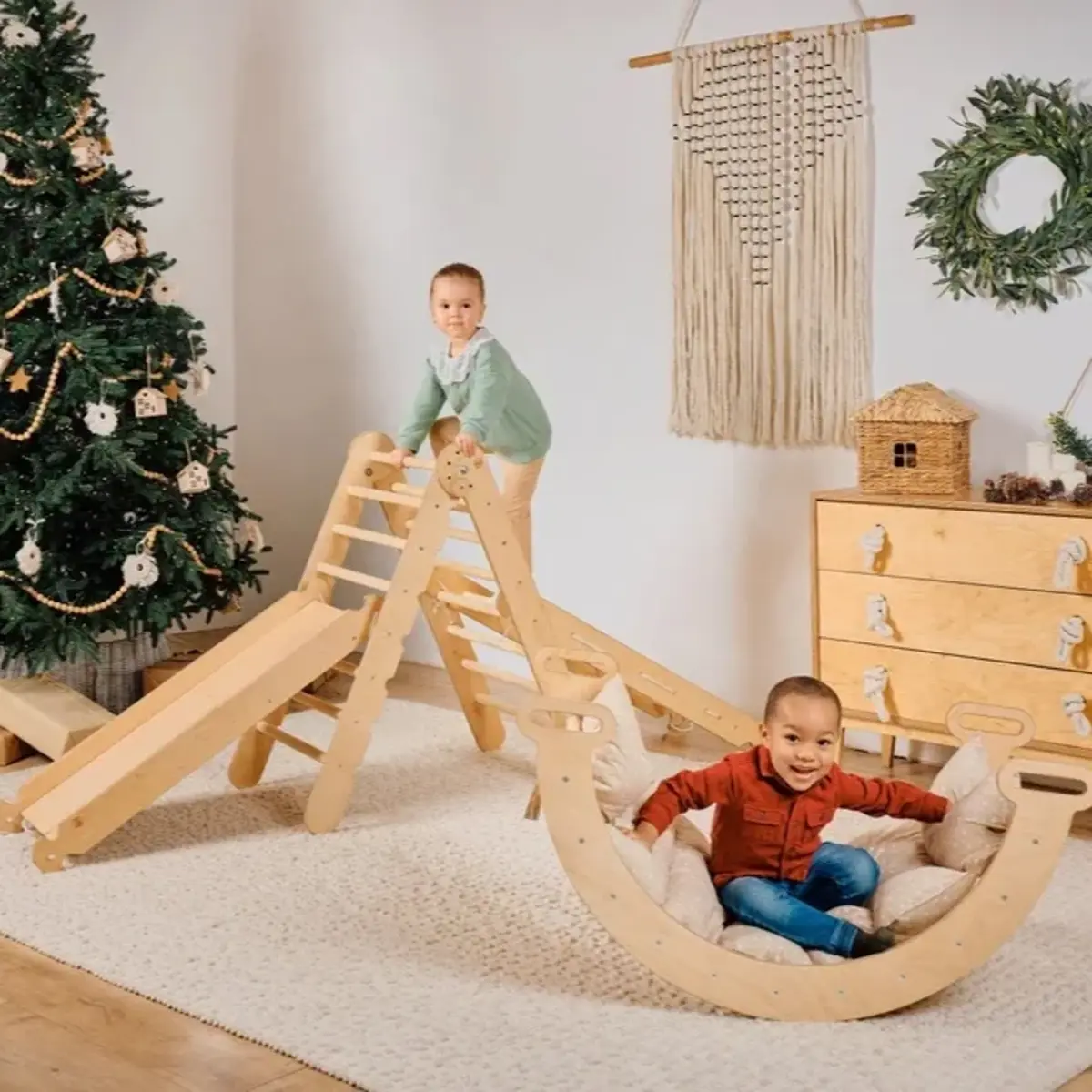 Two children playing on a wooden Good Evas climbing set