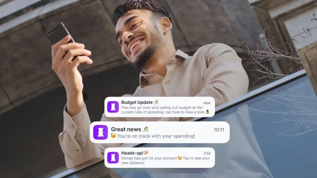 A man checking budgeting updates on his phone