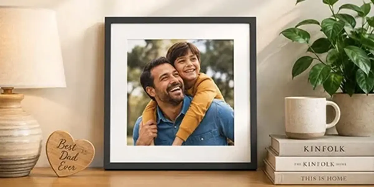 A framed photo of a dad and child on a shelf