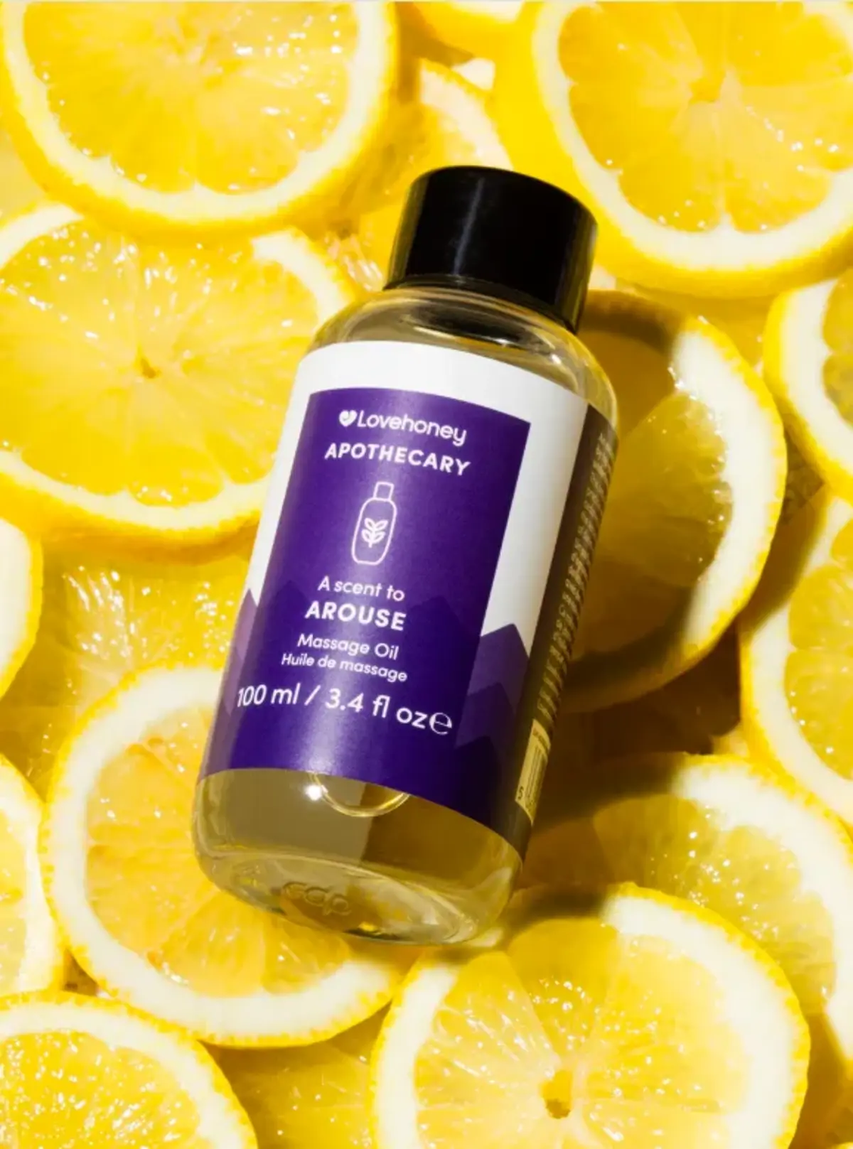 A bottle of arousal oil on a bed of lemon slices