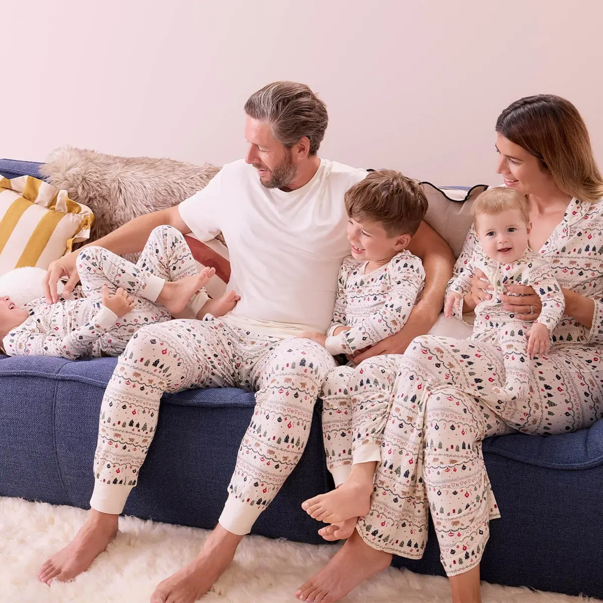 A family of five in matching white Christmas pyjamas