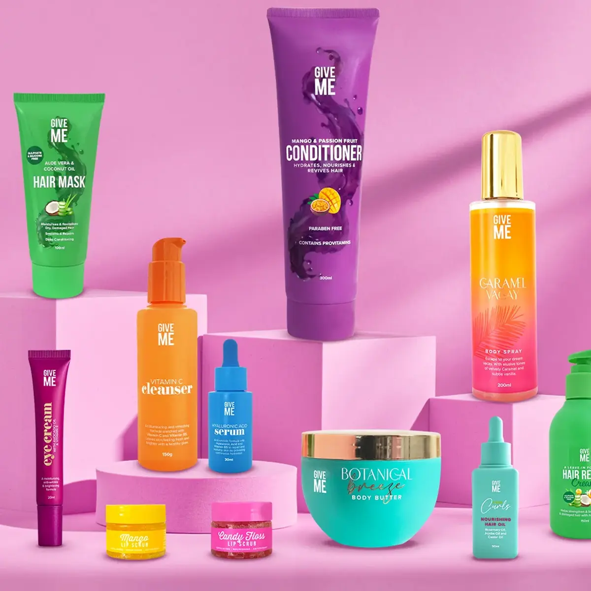 Give Me Cosmetics haircare lined up on pink