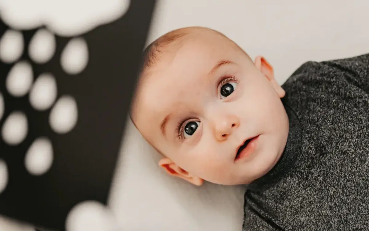 A baby studying a black-and-white contrast card