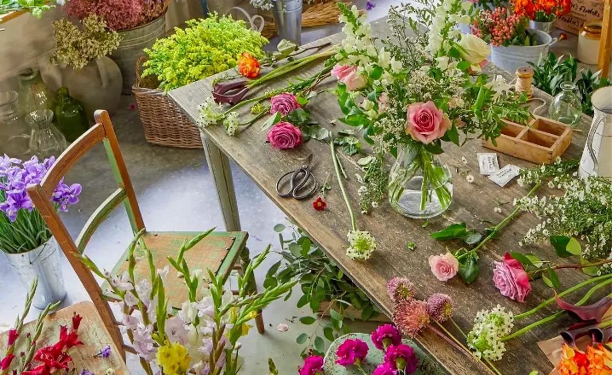 A florist's bench covered in fresh spring flowers