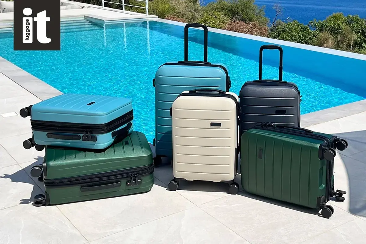Antler suitcases lined up beside a pool