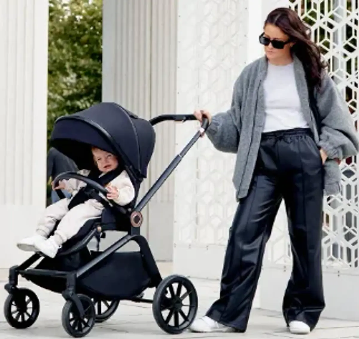 A mum pushing her baby in an Ickle Bubba pram