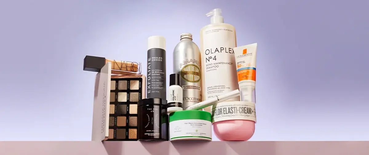 A collection of beauty products on a lilac background
