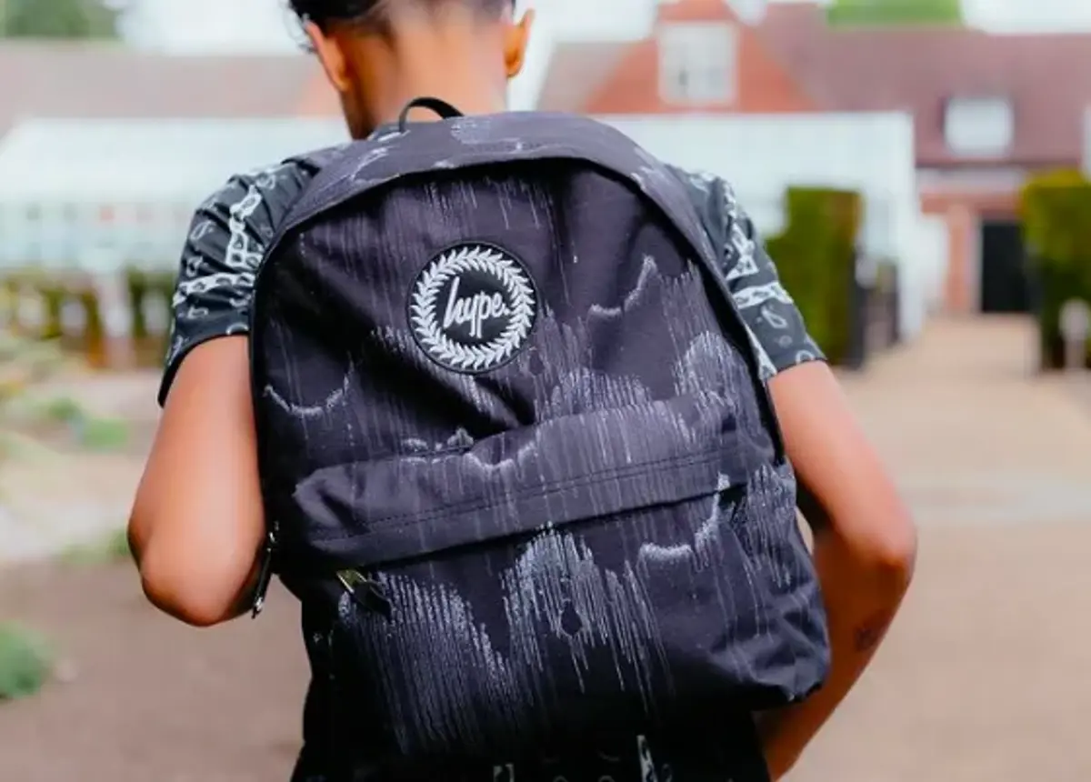 A boy wearing a black Hype backpack
