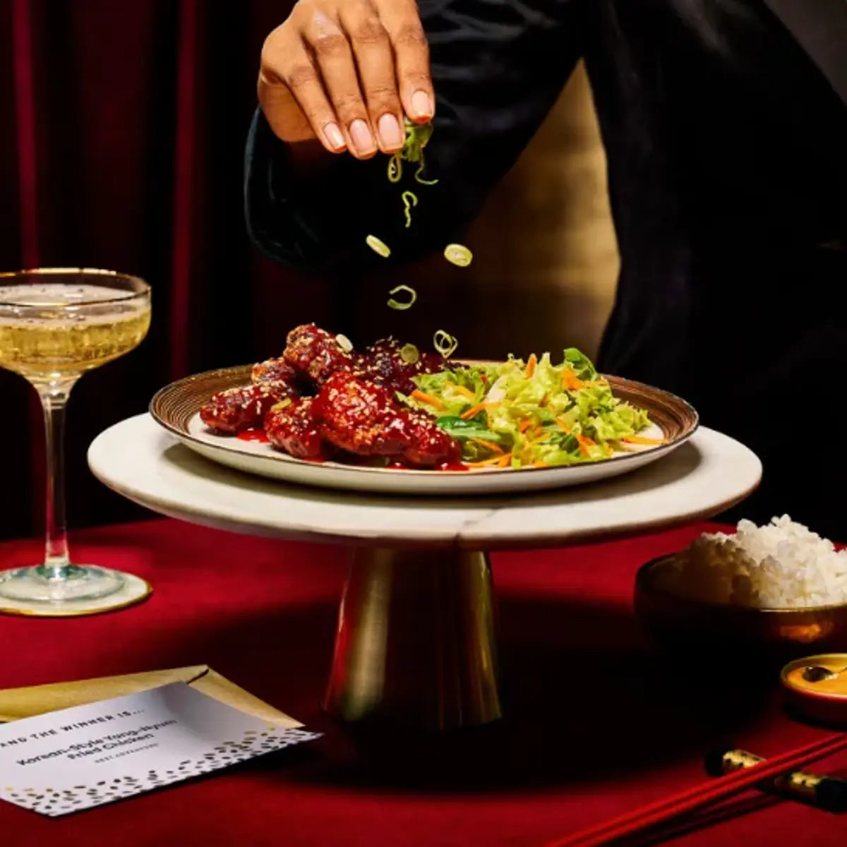 A Gousto dinner plated up beside a cocktail