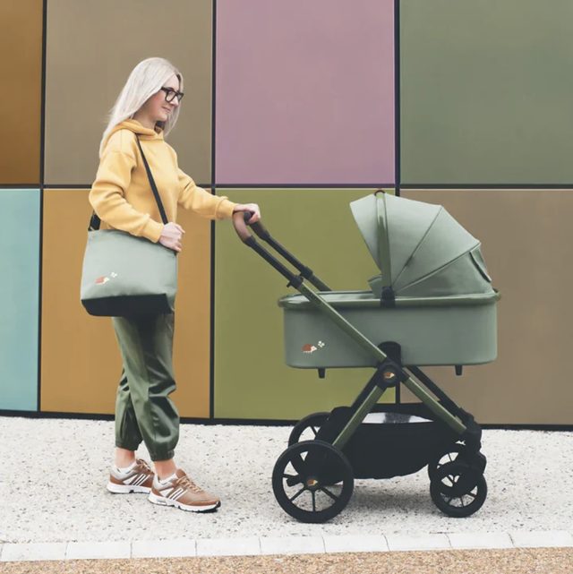 Mum pushing green Cosatto pram