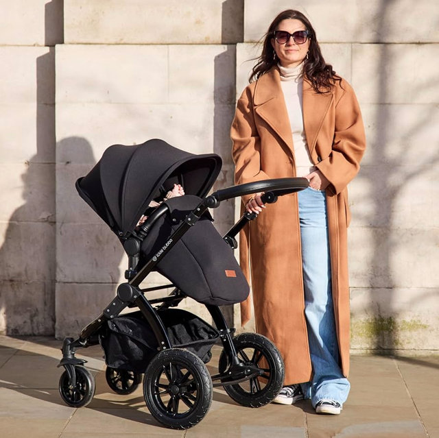 Mum standing next to pram